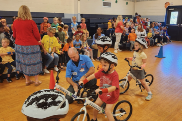 The big reveal at White Oak Elementary pairs the bikes Yamaha assembled with kindergarteners who are learning to ride bikes in PE class as part of the All Kids Bike program.