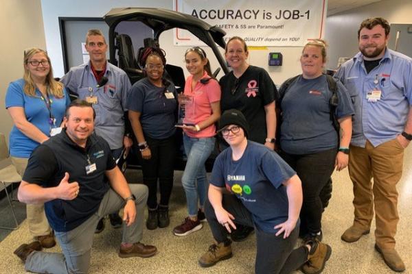 The Yamaha Ergonomics Class graduates learned effective ways to apply ergo to increase safety and efficiency on the assembly line. They include from left to right: Anne Mecke, Chris Taylor, Hadiya Harden, Lenn Casterline, Angela White, Emily Gregory, Drew Hood. Kneeling: Brock Anderson (instructor), Jennifer Winkles. Graduates not pictured:  Billy Mcglamory, Victoria Karakos, Cameron Coker